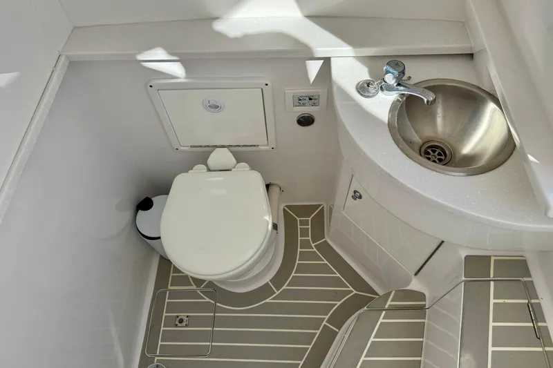 Slide: The Image of 2024 Intrepid 407 Nomad FE boat bathroom with toilet and stainless steel sink. - 37