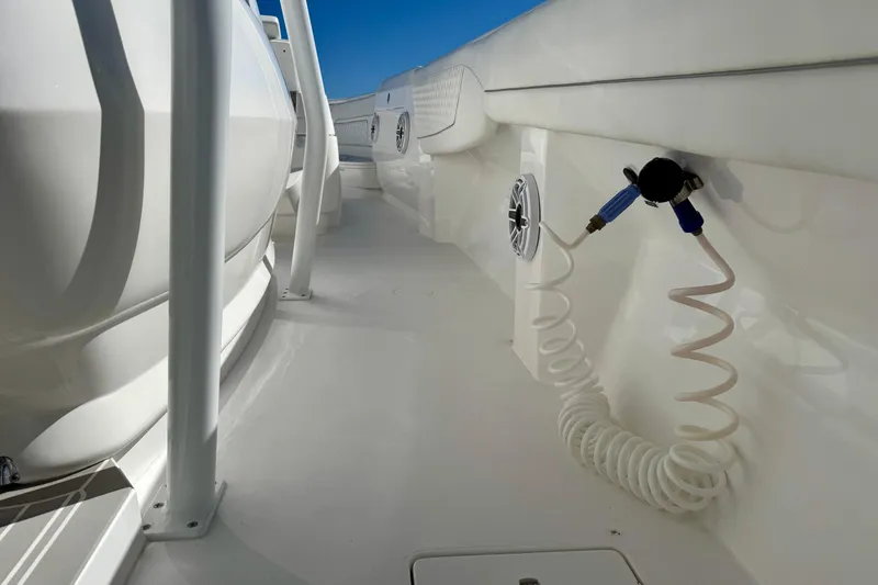 Slide: The Image of 2024 Intrepid 407 Nomad FE boat deck with coiled hose and speaker. - 38