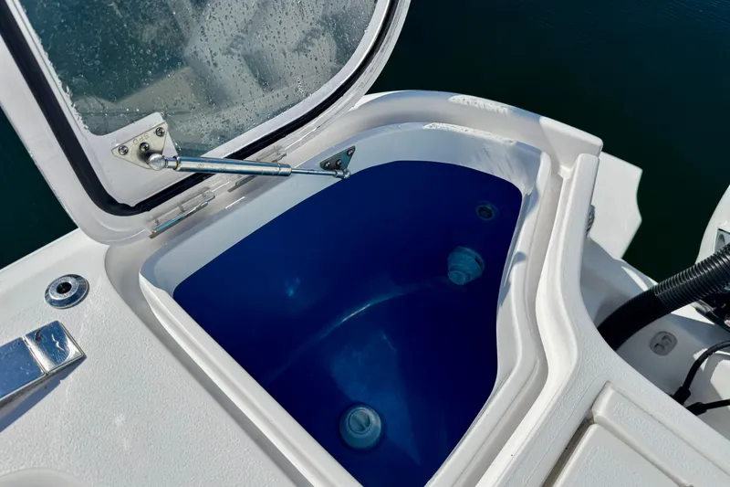 Slide: The Image of Open storage compartment on 2024 Intrepid 407 Nomad FE boat, featuring blue interior. - 41