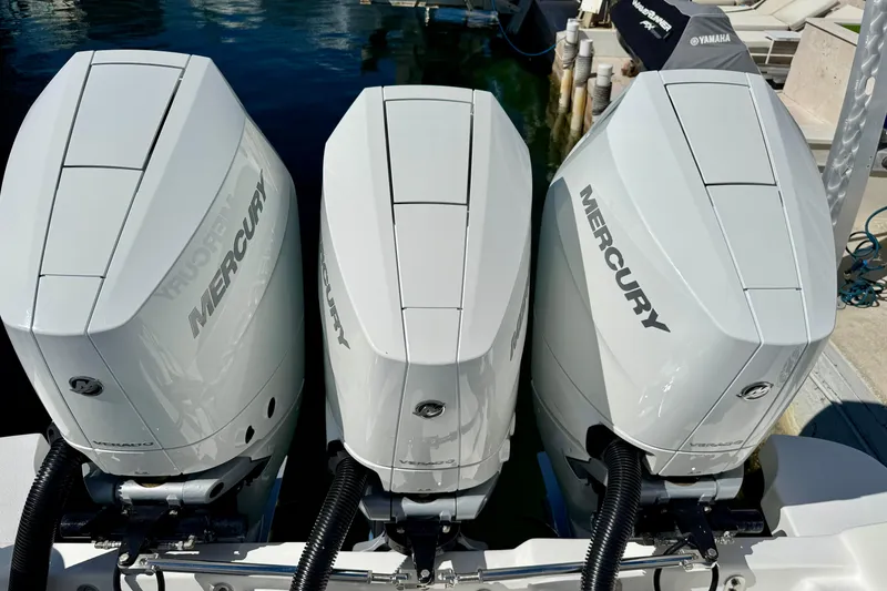 Slide: The Image of Triple Mercury outboard engines on a 2024 Intrepid 407 Nomad FE boat at a dock. - 43
