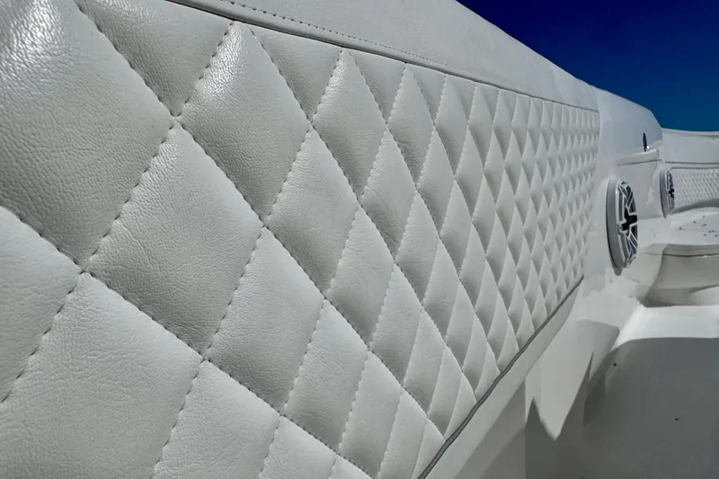Slide: The Image of 2024 Intrepid 407 Nomad FE boat interior with diamond-stitched upholstery and speakers. - 47