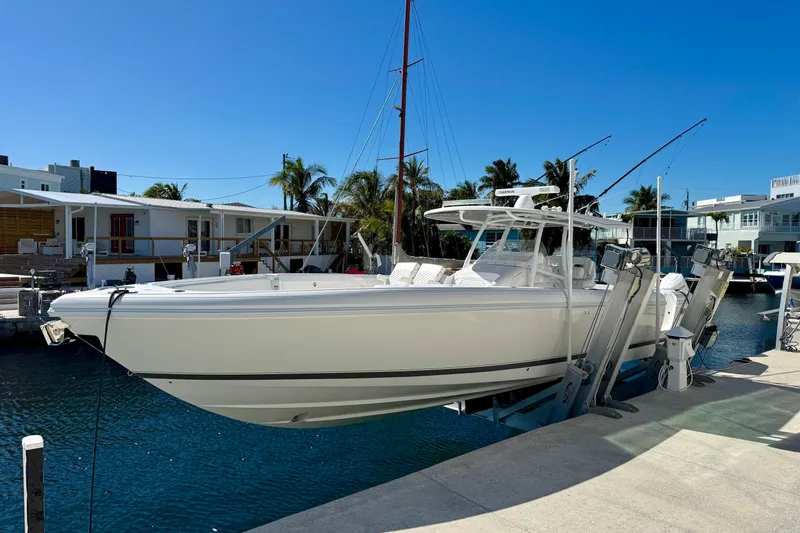 Slide: The Image of 2024 Intrepid 407 Nomad FE boat docked in a sunny marina setting. - 51