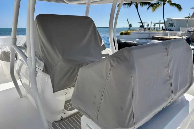 Slide: The Image of 2024 Intrepid 407 Nomad FE boat seats covered, ocean view in background. - 55