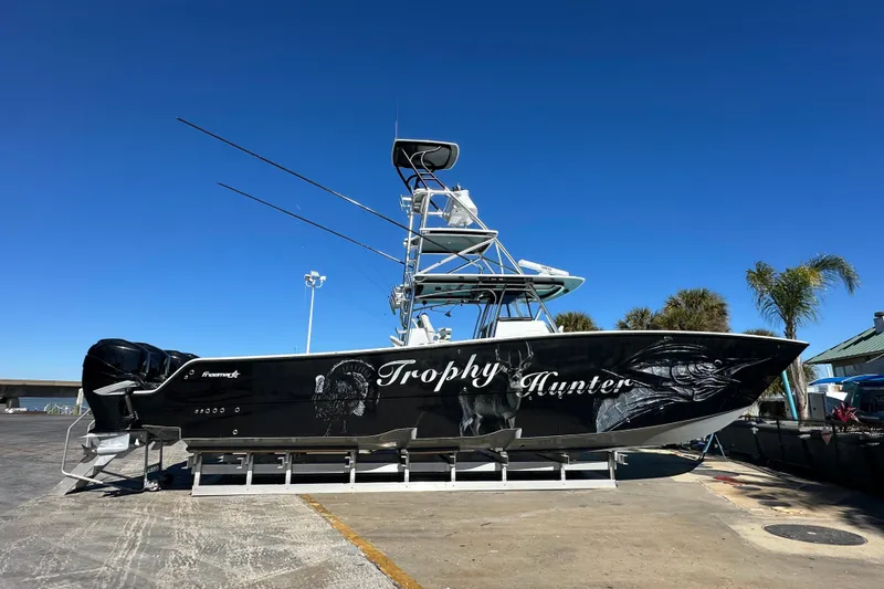 The Image of Freeman 42LR 2023 boat "Trophy Hunter" on display, featuring sleek black design and fishing equipment. - 0
