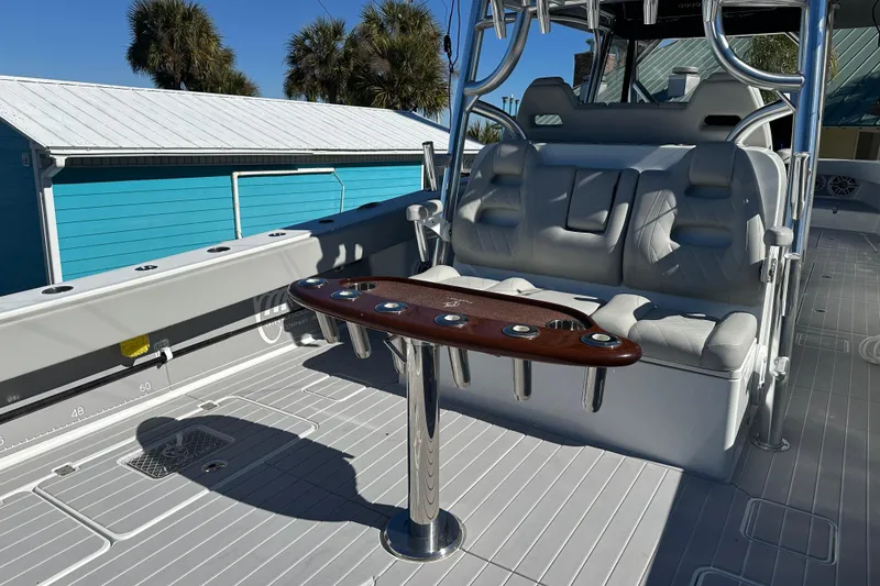 Slide: The Image of Luxurious seating area on a 2023 Freeman 42LR boat with rod holders and sleek design. - 11