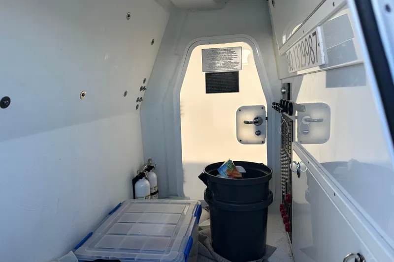 Slide: The Image of Interior of a 2023 Freeman 42LR boat with storage and safety equipment. - 19