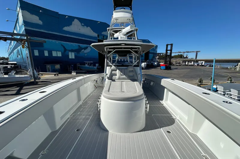 Slide: The Image of 2023 Freeman 42LR boat docked, showcasing spacious deck and modern design. - 6