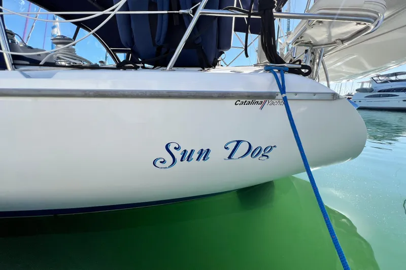 Slide: The Image of 1998 Catalina 36 MkII sailboat named "Sun Dog" docked in marina. - 13