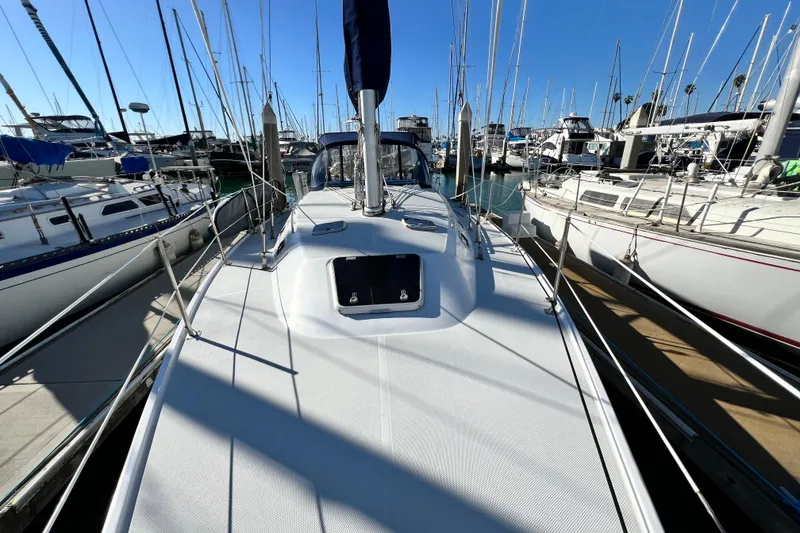 Slide: The Image of 1998 Catalina 36 MkII sailboat docked in a marina, surrounded by other boats. - 17