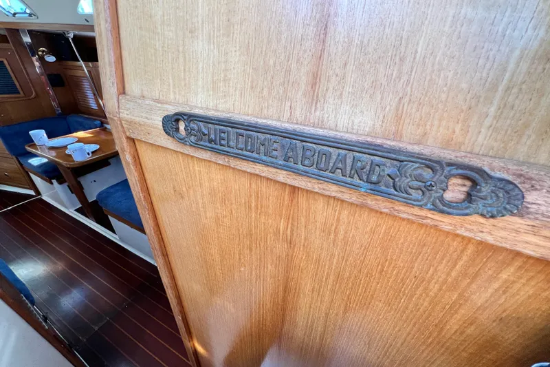 Slide: The Image of Welcome sign on 1998 Catalina 36 MkII yacht interior with wooden finish and cozy seating. - 32