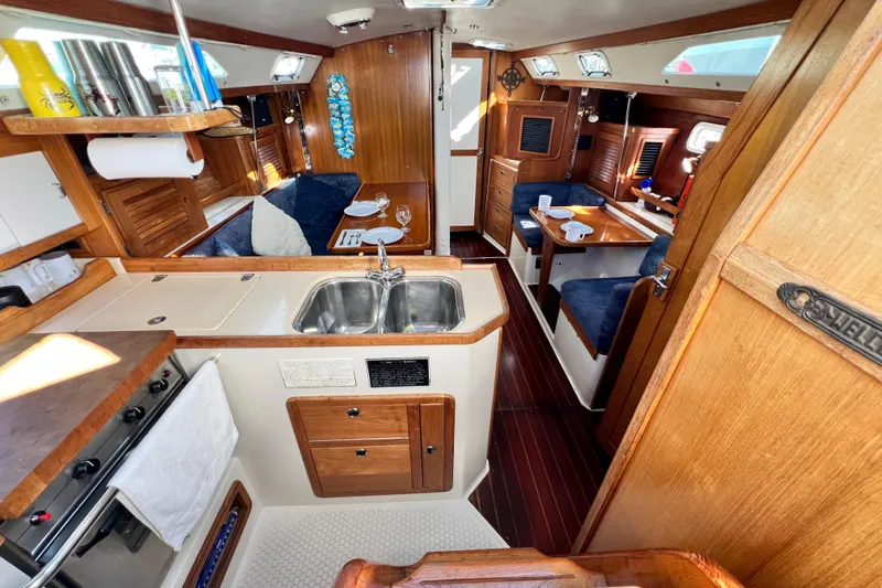 Slide: The Image of Interior of a 1998 Catalina 36 MkII sailboat with cozy seating and kitchen area. - 33