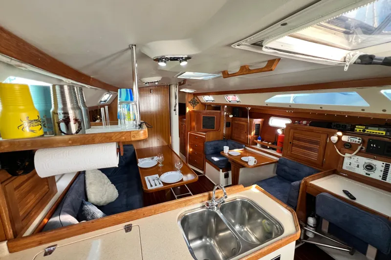 Slide: The Image of Interior of a 1998 Catalina 36 MkII sailboat, featuring a cozy dining and kitchen area. - 35