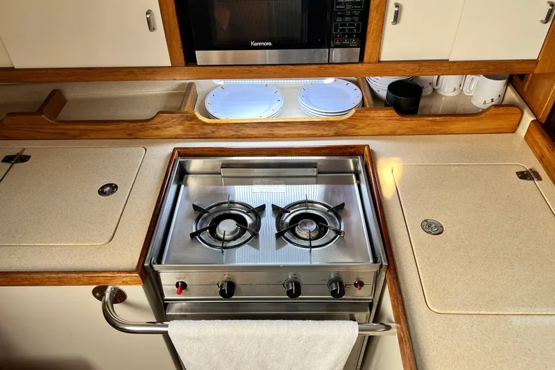 Slide: The Image of Compact kitchen in a 1998 Catalina 36 MkII yacht with stove and microwave. - 37