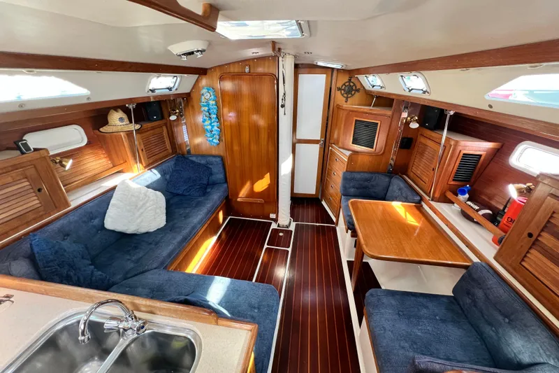 Slide: The Image of Interior of a 1998 Catalina 36 MkII sailboat with cozy seating and wooden finishes. - 38