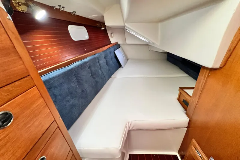 Slide: The Image of Interior cabin of a 1998 Catalina 36 MkII sailboat with cozy bedding and wooden accents. - 41