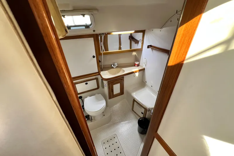 Slide: The Image of Bathroom interior of 1998 Catalina 36 MkII sailboat, featuring wood accents and compact design. - 48
