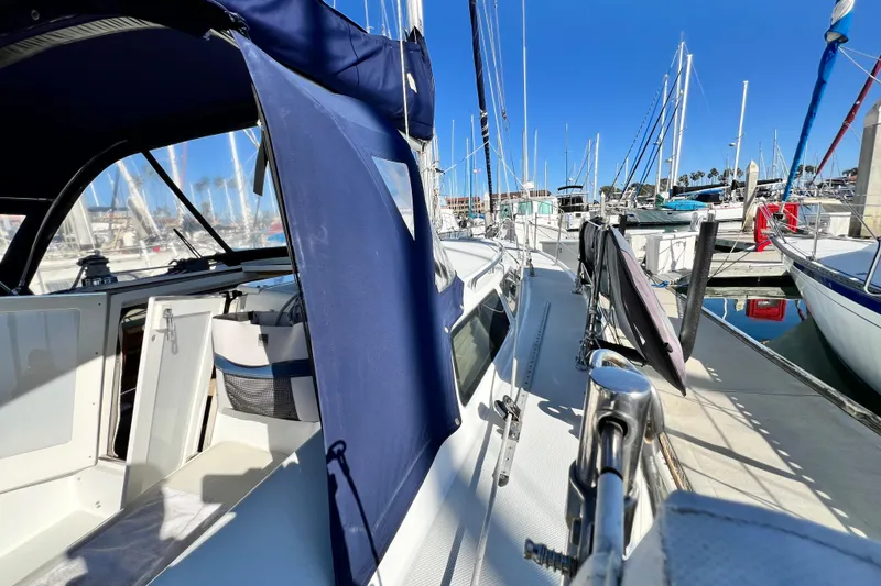 Slide: The Image of 1998 Catalina 36 MkII sailboat docked at marina under clear blue sky. - 6