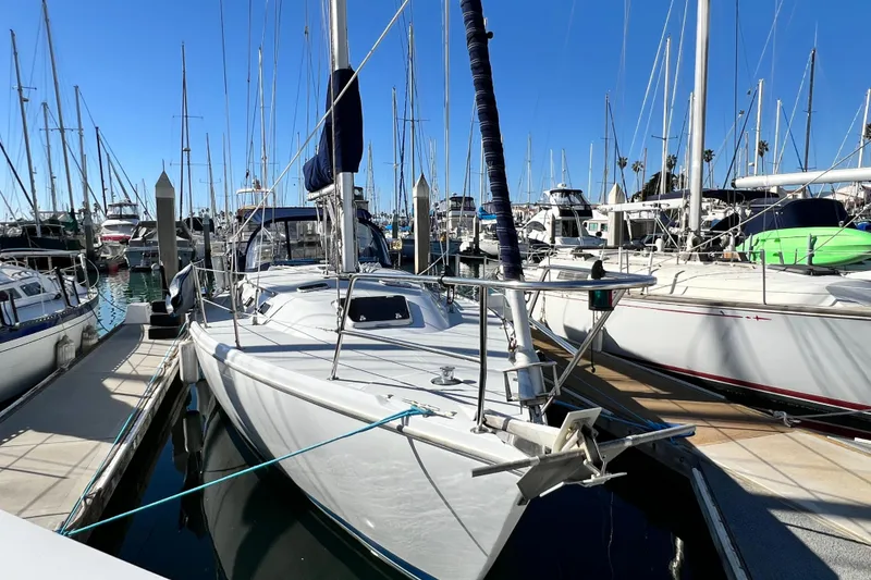 Slide: The Image of 1998 Catalina 36 MkII sailboat docked in a marina under clear blue skies. - 7