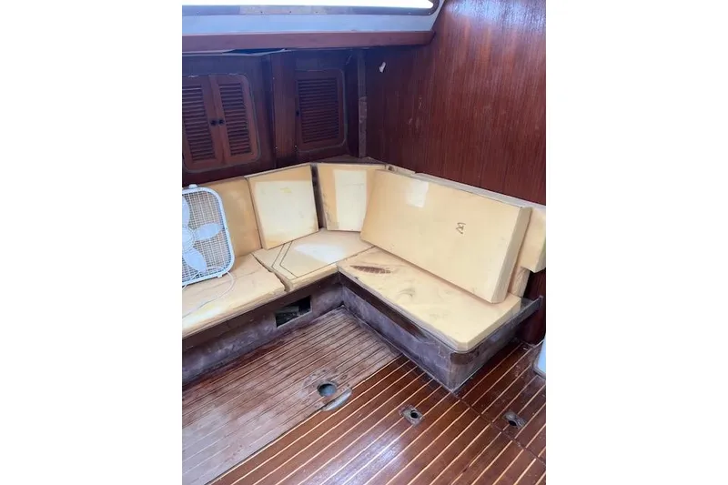 Slide: The Image of Interior of 1998 Tayana 55 yacht with wooden flooring and cushioned seating. - 12