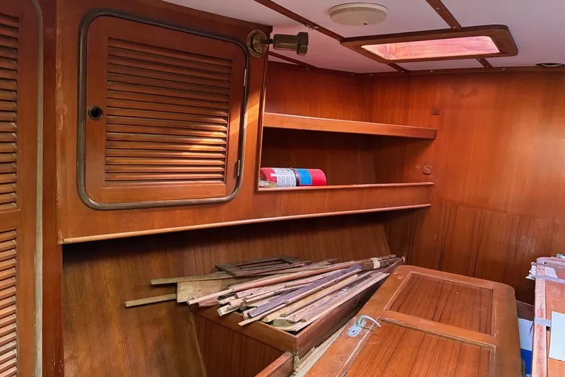 Slide: The Image of Interior of 1998 Tayana 55 sailboat with wooden cabinetry and shelves. - 17