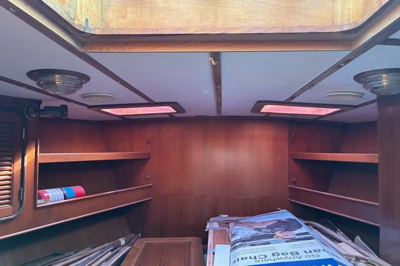 Slide: The Image of Interior of 1998 Tayana 55 sailboat with wooden shelves and ceiling lights. - 19