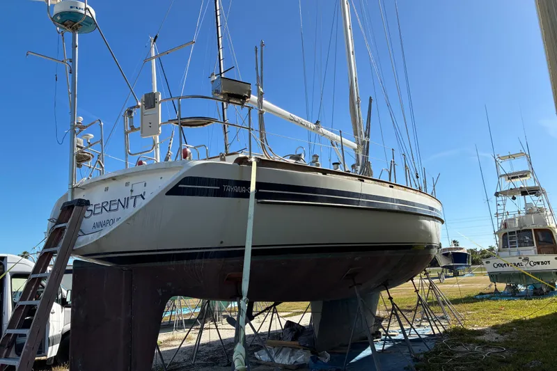 Slide: The Image of Sailboat Tayana 55, 1998 model, on dry dock under clear blue sky. - 2