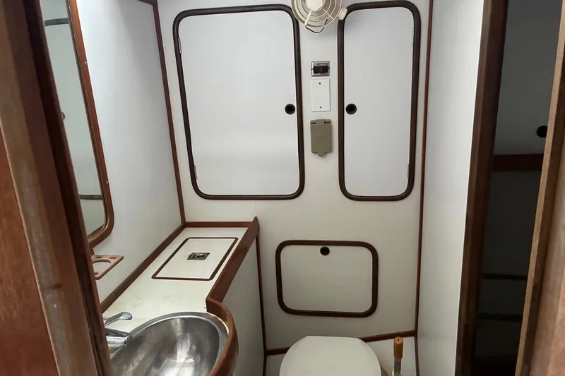 Slide: The Image of Bathroom interior of 1998 Tayana 55 yacht with sink, toilet, and storage cabinets. - 23