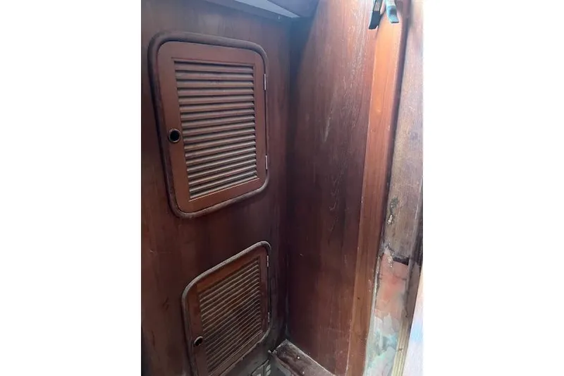 Slide: The Image of Wooden interior of 1998 Tayana 55 sailboat with louvered cabinet doors. - 26