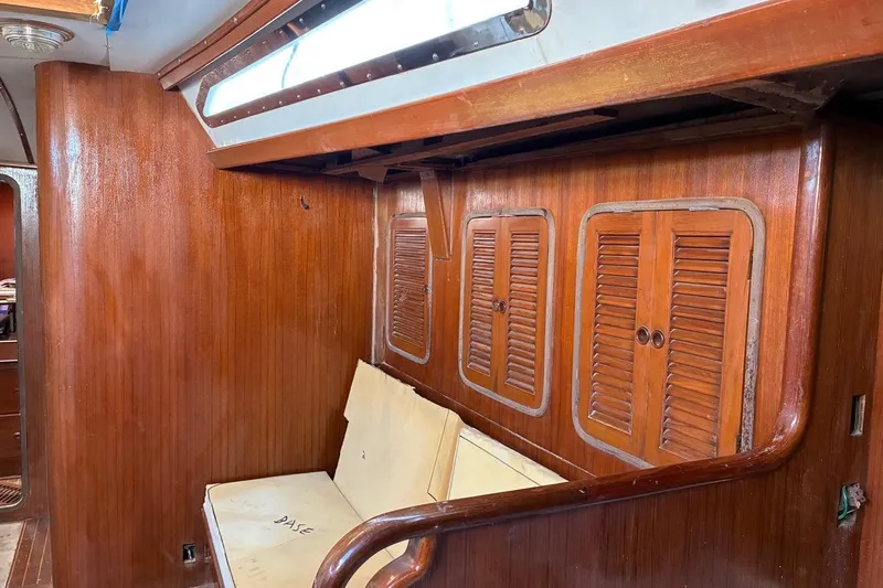 Slide: The Image of Interior of 1998 Tayana 55 yacht with wooden paneling and built-in seating. - 29