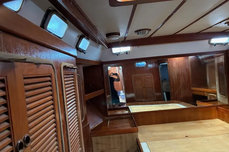 Slide: The Image of Interior of 1998 Tayana 55 yacht with wooden cabinetry and portholes. - 34