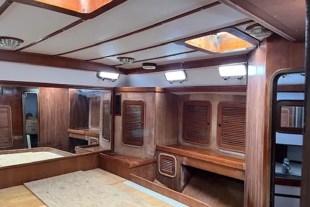 Slide: The Image of Interior of 1998 Tayana 55 yacht with wooden paneling and built-in storage. - 37