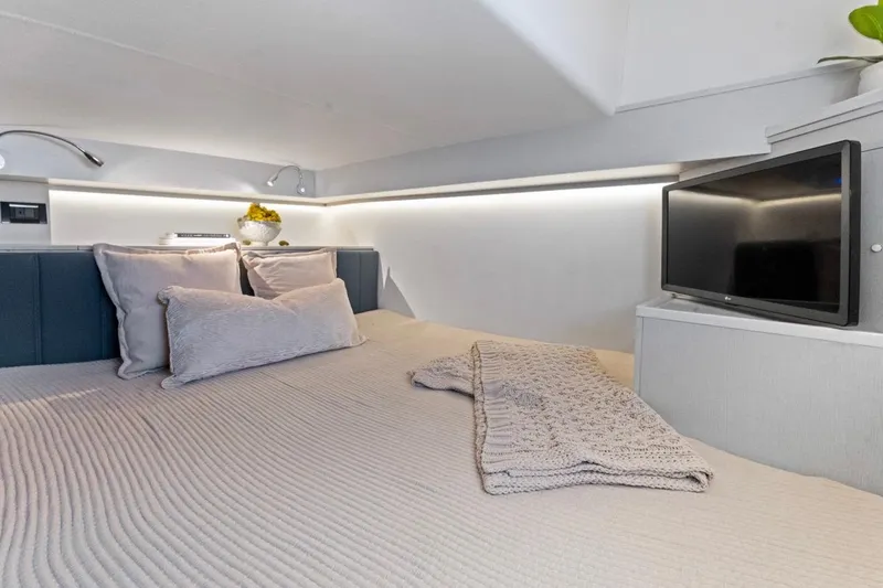 Slide: The Image of Luxurious interior of 2026 Valiatt 350 GT with cozy bedding and modern TV setup. - 6