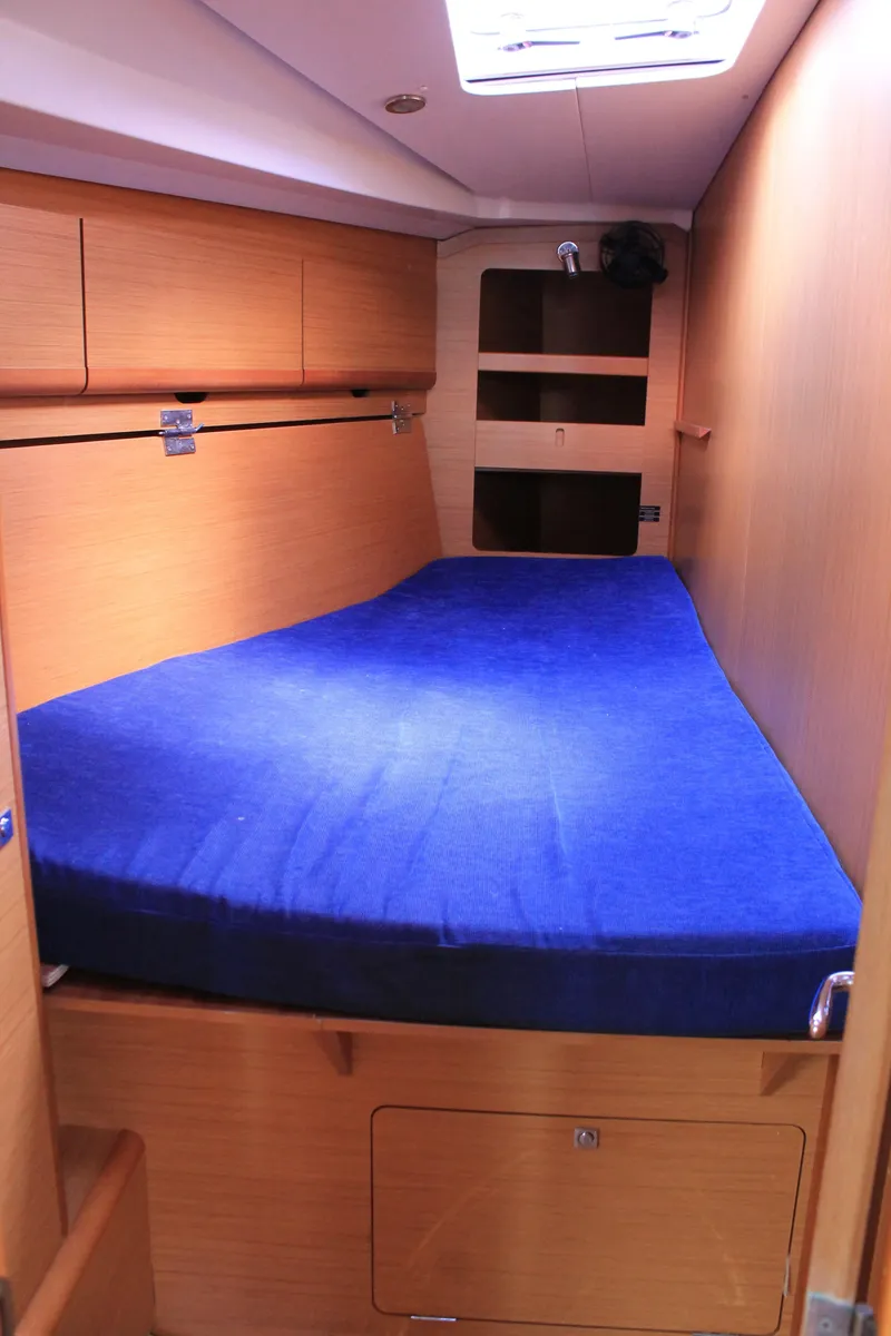 Slide: The Image of Cabin of Jeanneau Sun Odyssey 44i, 2010 model, featuring a blue bed. - 12