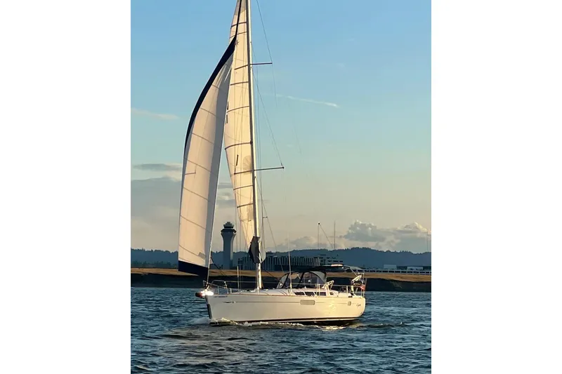Slide: The Image of 2010 Jeanneau Sun Odyssey 44i sailing on calm waters at sunset. - 25