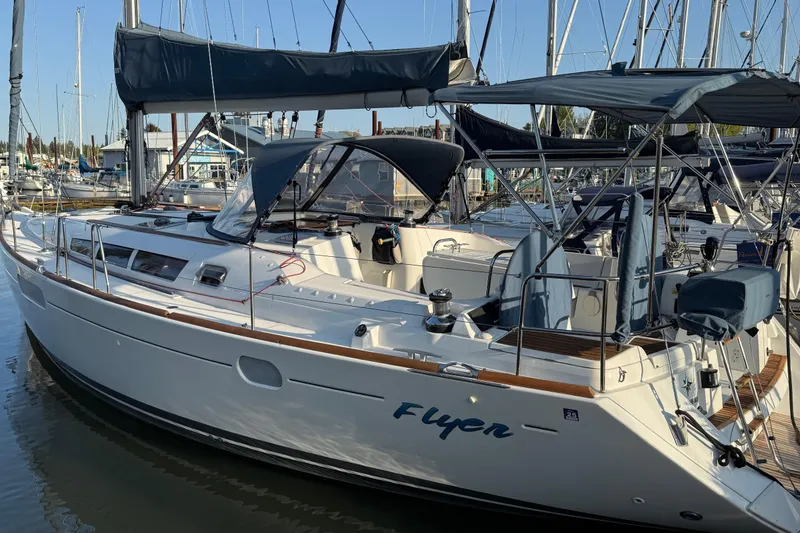 Slide: The Image of 2010 Jeanneau Sun Odyssey 44i sailboat docked in marina, featuring sleek design and spacious deck. - 29