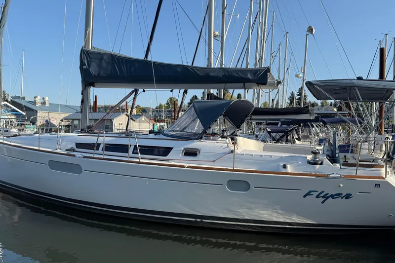 Slide: The Image of 2010 Jeanneau Sun Odyssey 44i sailboat docked in marina, clear sky background. - 30