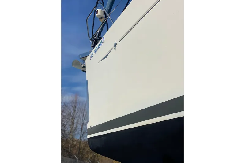 Slide: The Image of 2010 Jeanneau Sun Odyssey 44i sailboat hull against blue sky. - 35