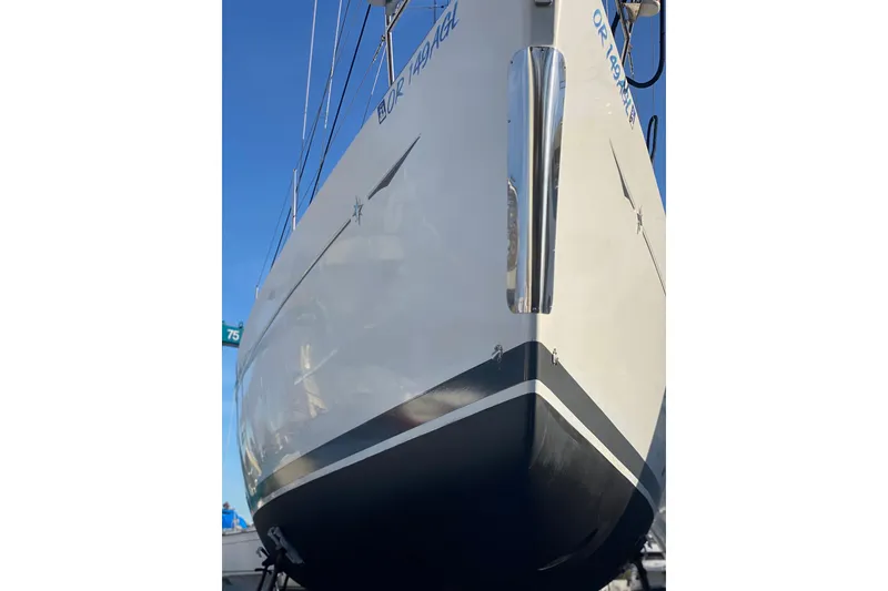 Slide: The Image of 2010 Jeanneau Sun Odyssey 44i sailboat, docked, showcasing sleek hull design. - 36