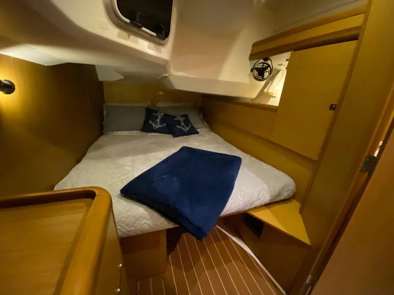 Slide: The Image of Jeanneau Sun Odyssey 44i 2010 cabin with cozy bed and wooden interior. - 9