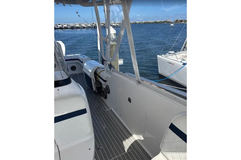 Slide: The Image of 2015 Intrepid 400 Cuddy boat interior with sleek design, docked by the water. - 17