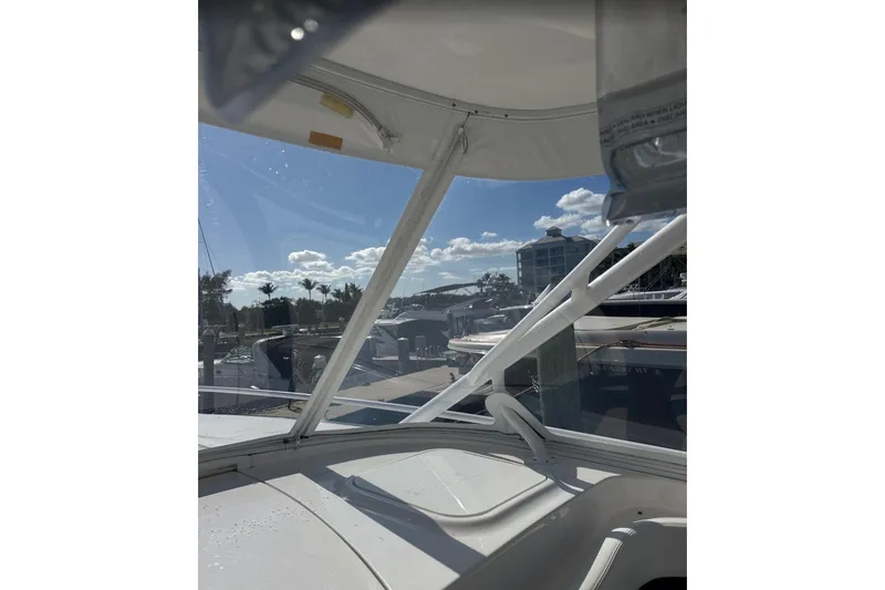 Slide: The Image of 2015 Intrepid 400 Cuddy boat interior view with marina background. - 20