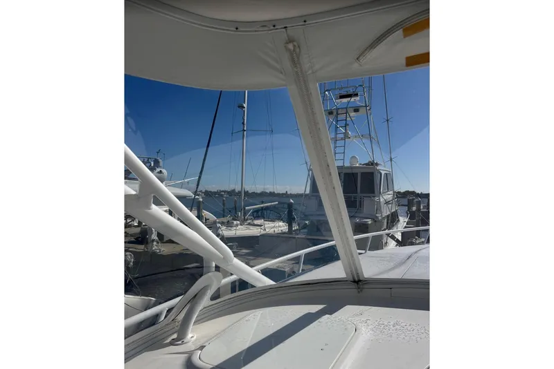 Slide: The Image of 2015 Intrepid 400 Cuddy yacht docked at marina, clear blue sky background. - 21