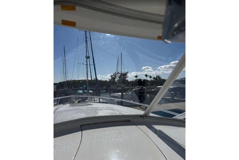 Slide: The Image of 2015 Intrepid 400 Cuddy yacht docked at marina under clear blue sky. - 22