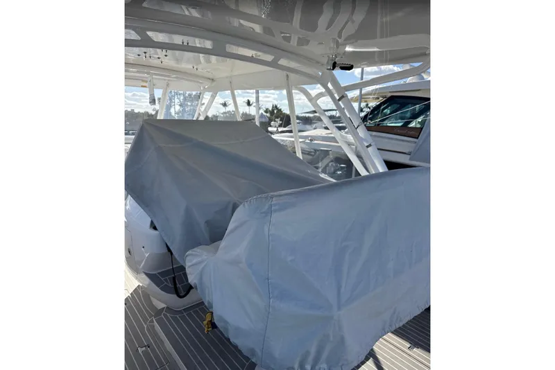 Slide: The Image of 2015 Intrepid 400 Cuddy boat interior with protective covers on seating. - 23