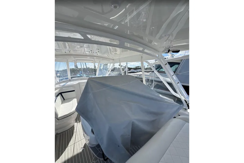 Slide: The Image of 2015 Intrepid 400 Cuddy interior with covered seating, showcasing sleek design and spacious layout. - 25
