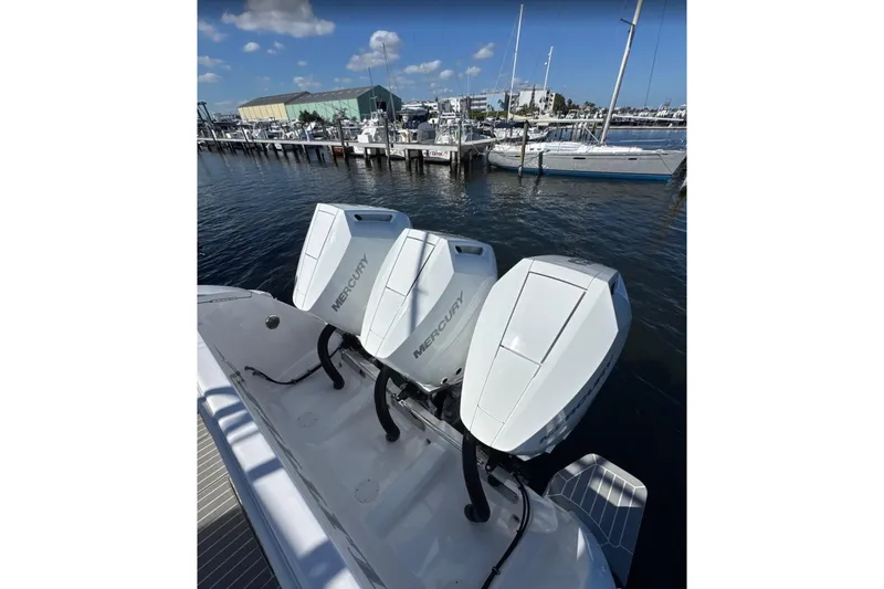 Slide: The Image of 2015 Intrepid 400 Cuddy with triple Mercury outboard engines docked at marina. - 26
