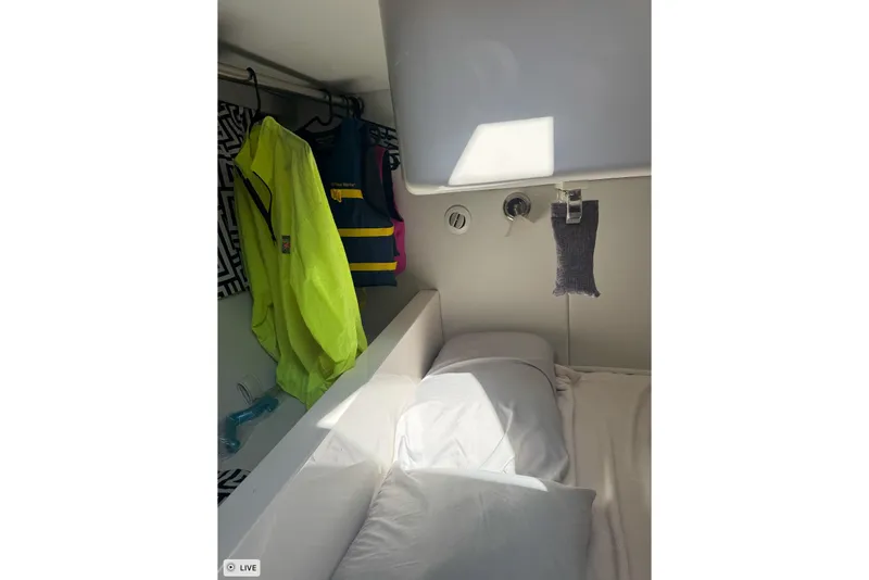 Slide: The Image of Cozy cabin interior of 2015 Intrepid 400 Cuddy with life jackets and bedding. - 27