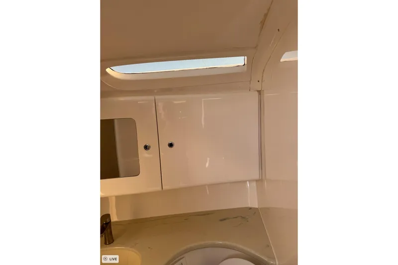 Slide: The Image of Interior of 2015 Intrepid 400 Cuddy boat, featuring sleek cabinetry and a small window. - 29