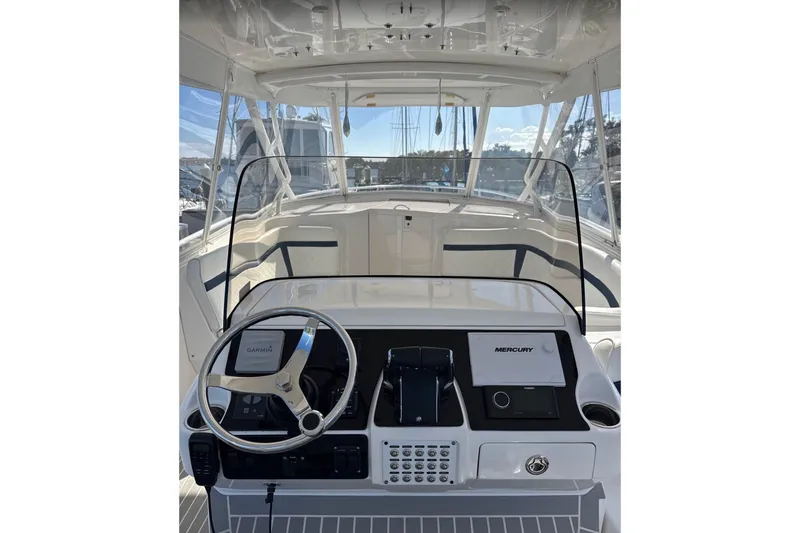 Slide: The Image of 2015 Intrepid 400 Cuddy helm with Garmin and Mercury controls, featuring a sleek design. - 3