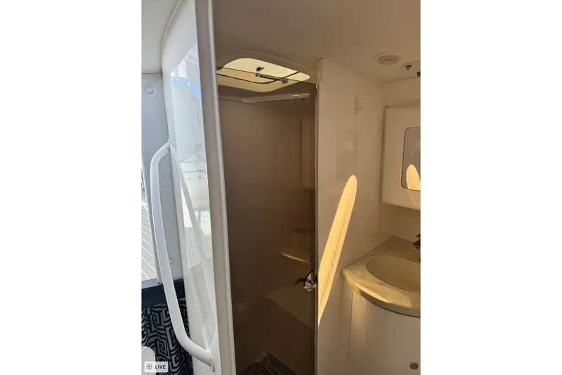 Slide: The Image of 2015 Intrepid 400 Cuddy interior bathroom with sink and shower. - 30